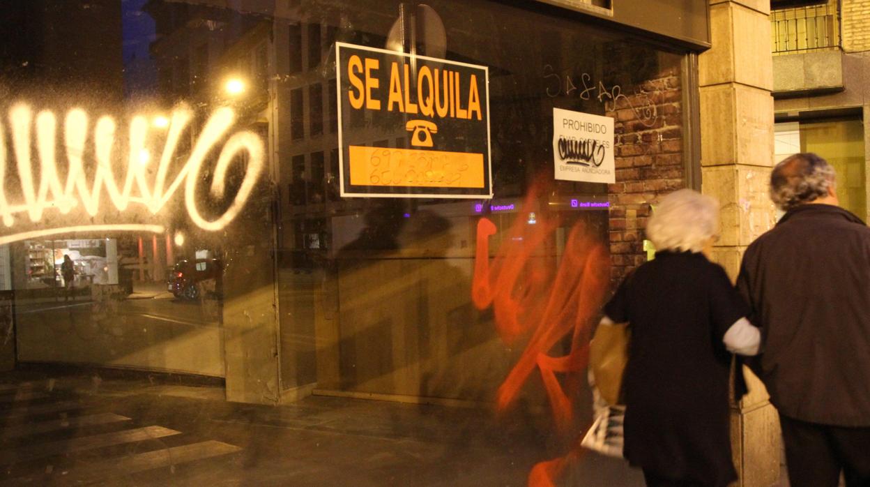 Cartel de «Se alquila» en el escaparate de un local vacío