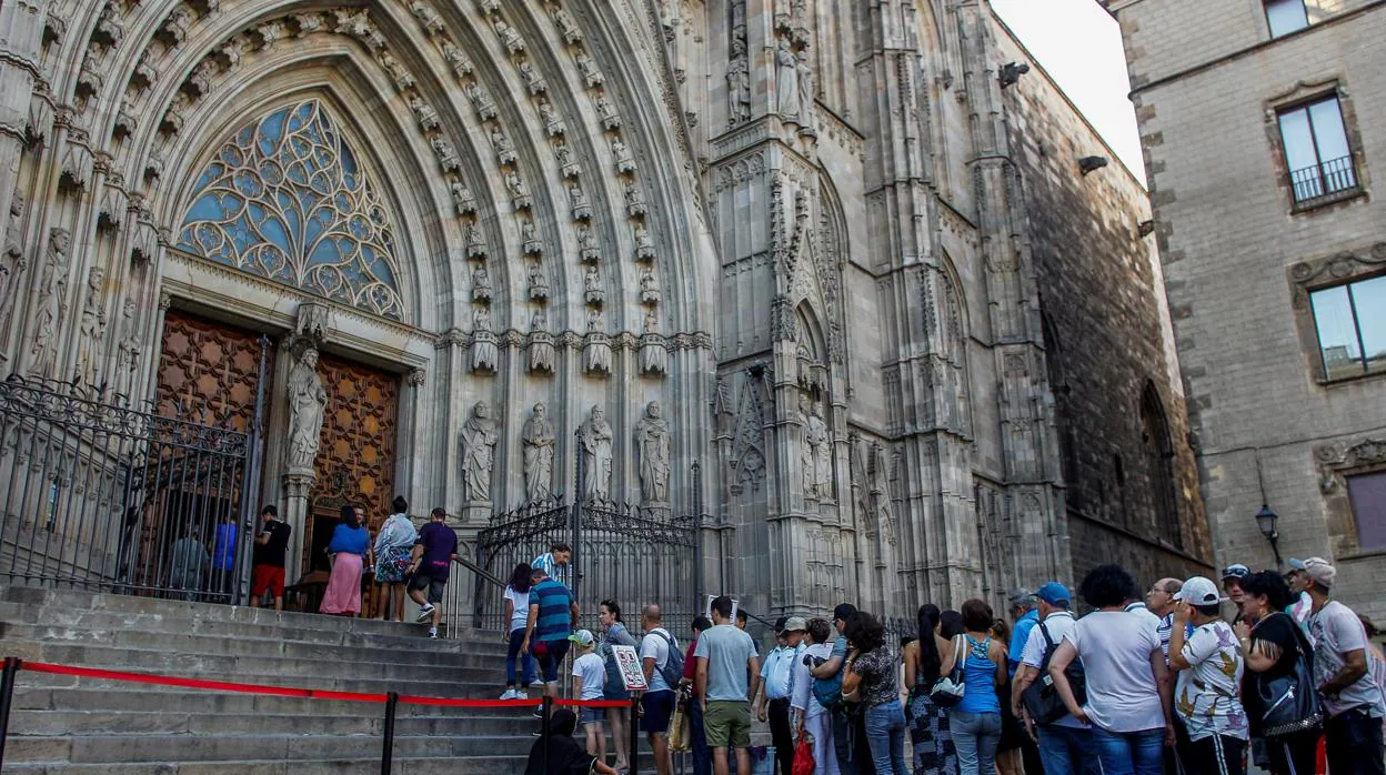 Turistas y feligreses en la entrada de la Catedral de Barcelona