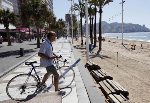 Un ciclista observa el litoral de Benidorm en la primera mañana de apertura al público tras el confinamiento