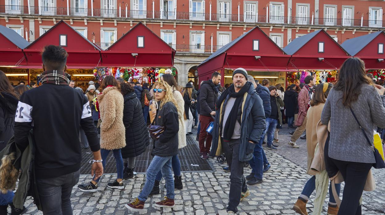 Varios ciudadanos pasen y compran en el mercadillo de Navidad de la Plaza Mayor, en 2019