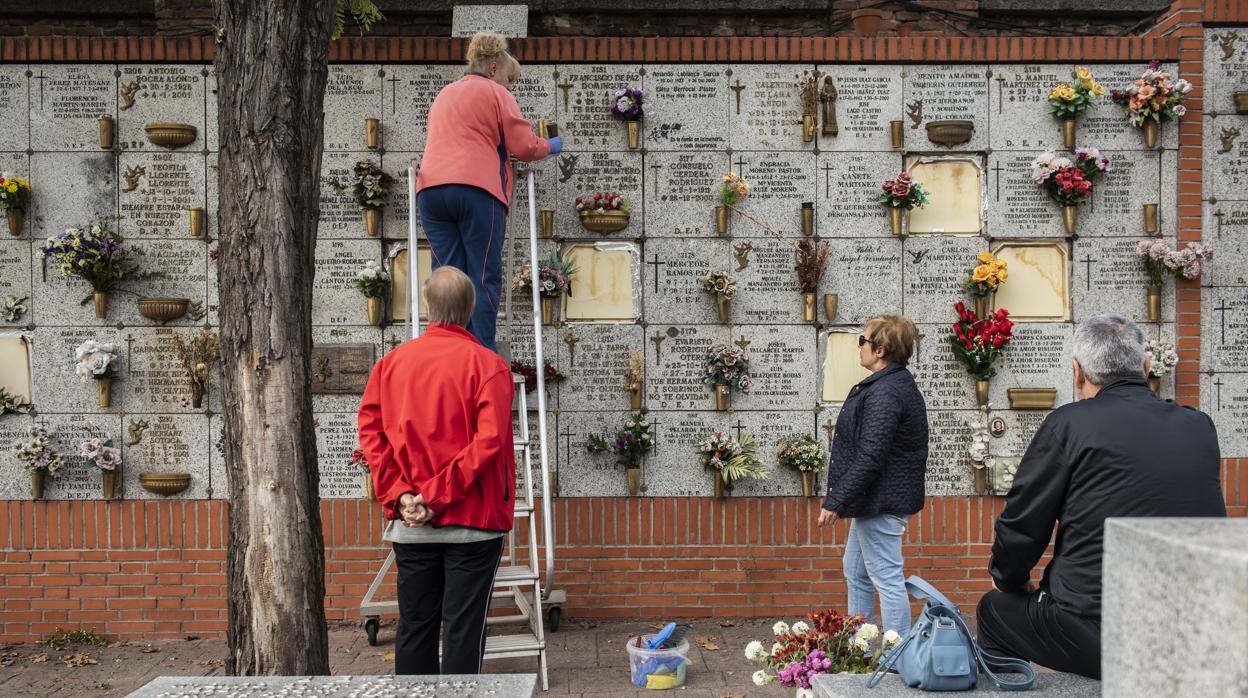 Varios ciudadanos colocan ramos de flores en las lápidas de sus difuntos, el año pasado en La Almudena