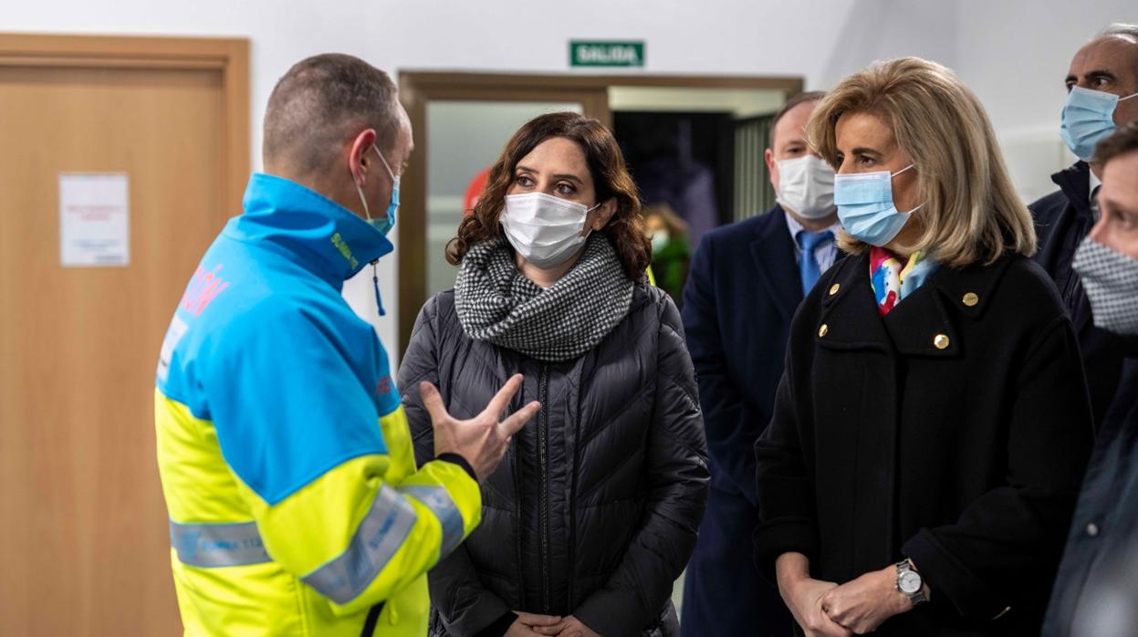 Isabel Díaz Ayuso y Fátima Báñez, con un responsable del Summa que realiza las pruebas en Mercamadrid