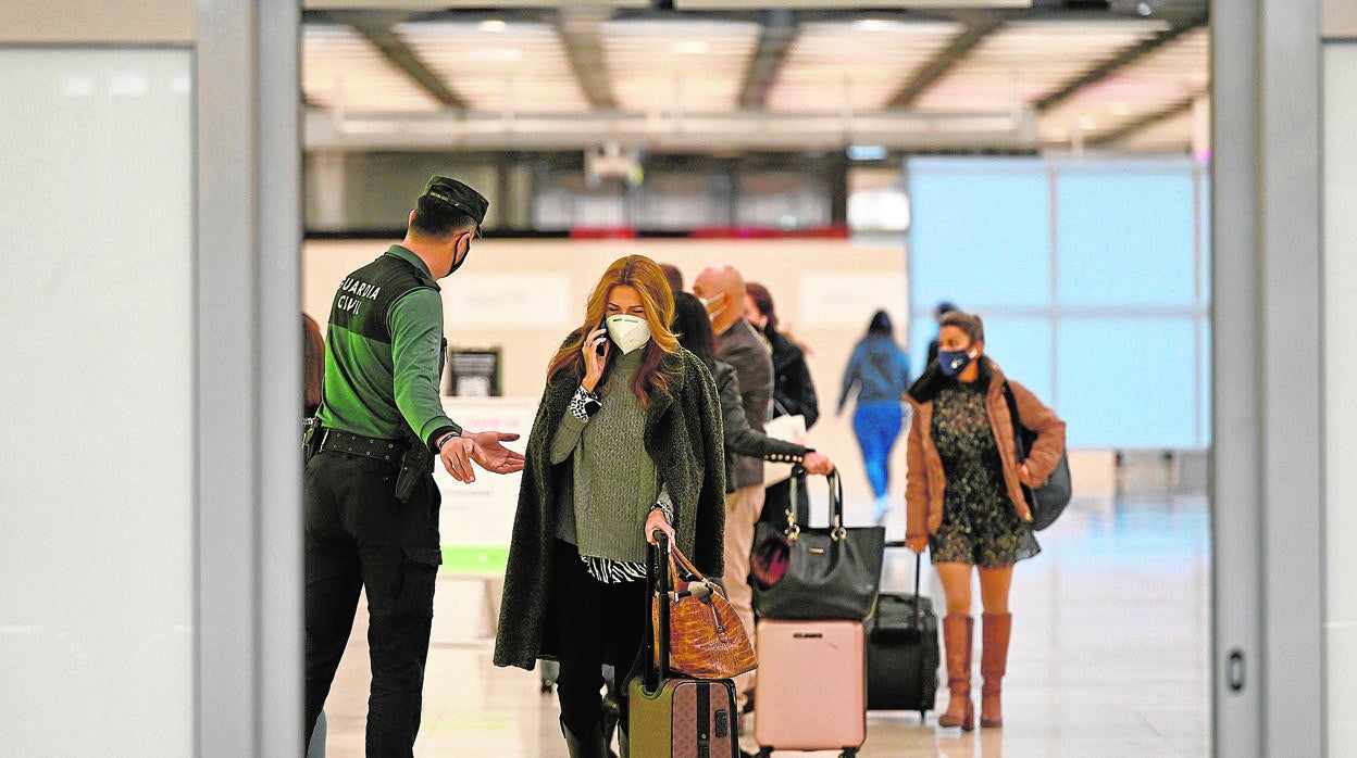 Pasajeros con mascarilla en un aeropuerto español