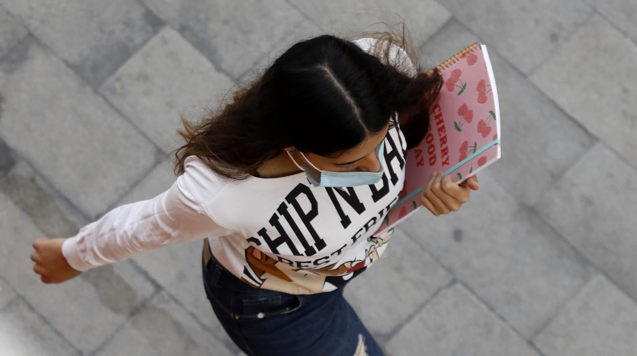 Una estudiante, ataviada con la mascarilla obligatoria