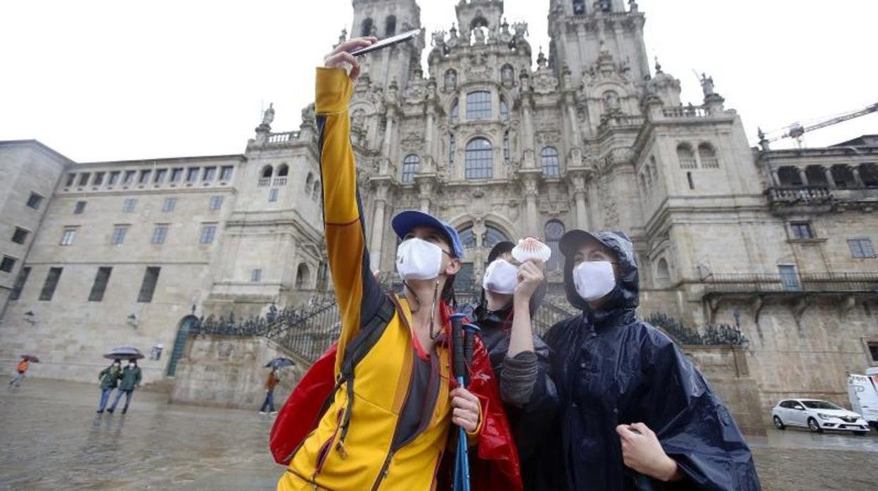 Peregrinos con mascarilla en la plaza del Obradoiro