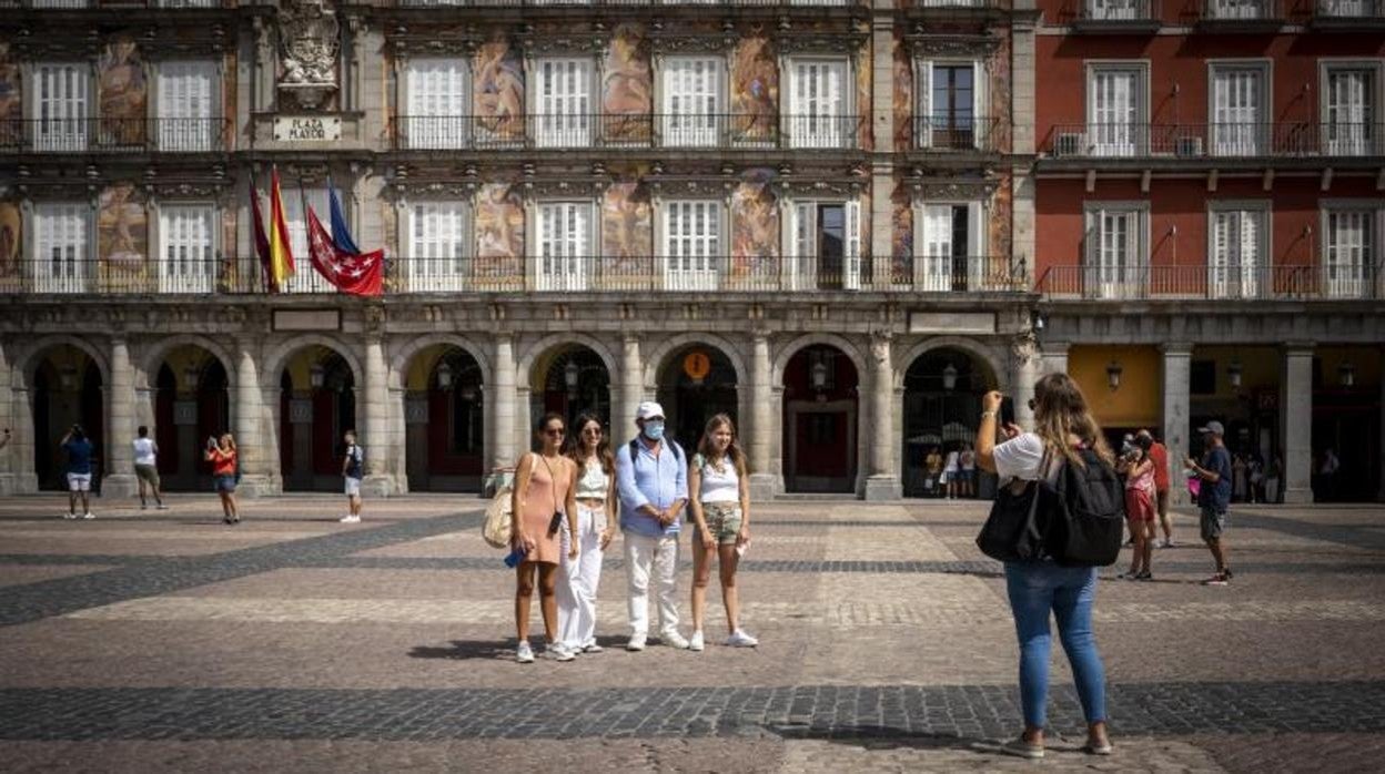 Un grupo de turistas se fotografía en la Plaza Mayor de Madrid