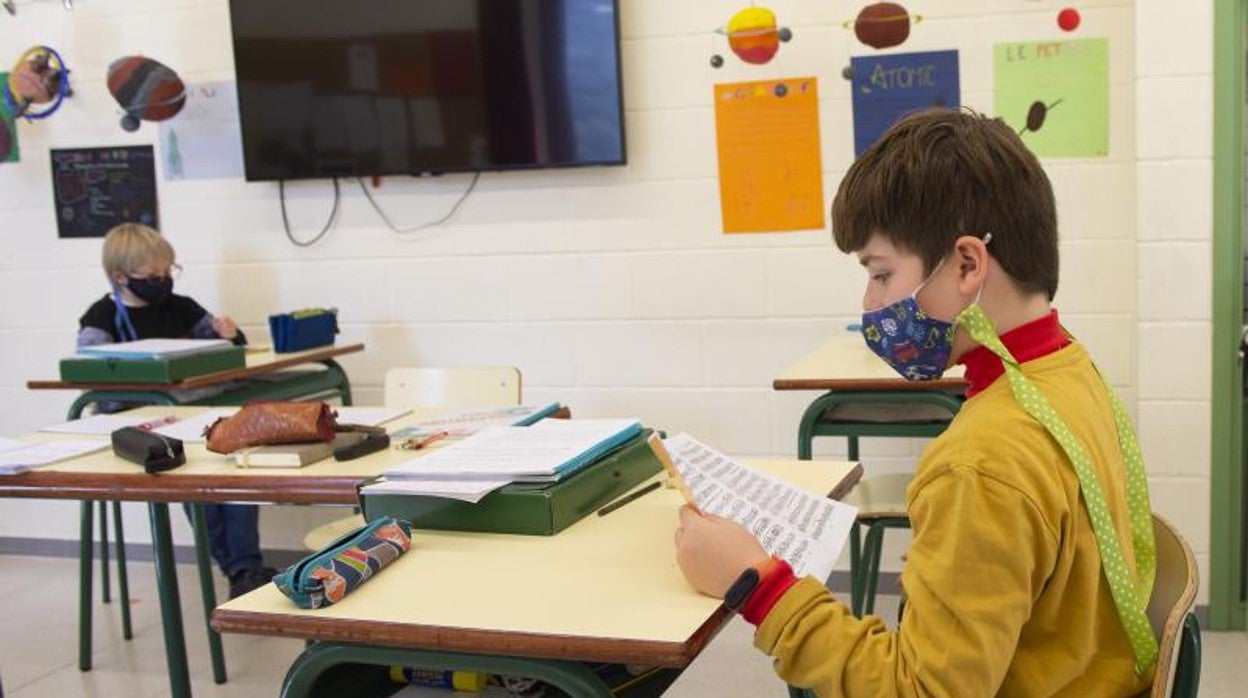 Un alumno, en clase con mascarilla
