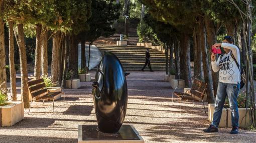 Una turista fotografía una de las esculturas expuestas en los jardines