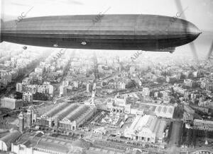 El Conde Zeppelin sobre Barcelona , al frente el palacio de arte textil y la...