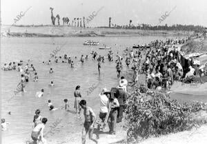 Personas bañandose en Sevilla, en el Río Guadalquivir
