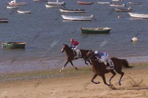 Dos jinetes compitiendo en el primer ciclo de las carreras de caballos