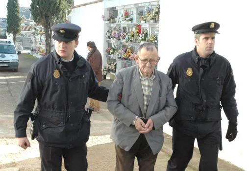 Antonio Izquierdo, uno de los asesinos de Puerto Hurraco, custodiado por dos policías, en el entierro de su hermano Emilio, en 2006.