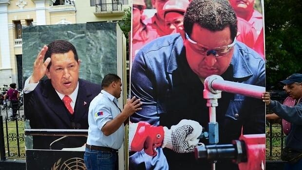 Empleados de la Asamblea Nacional de Venezuela quitan de edificios públicos de las imágenes de Hugo Chávez, en Caracas