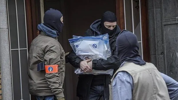 Varios policías belgas recogen pruebas de una vivienda del número 64 de la calle Busselenberg, en el distrito de Anderlecht-Bruselas