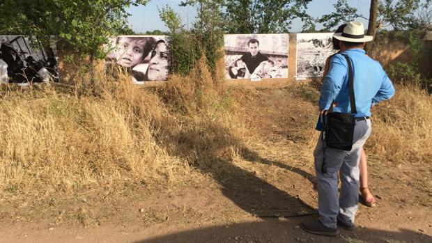 Un hombre contempla una de las fotografías expuestas en «Fotos en el camino: refugiados»