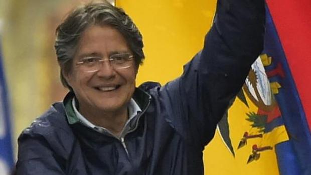 Guillermo Lasso, con la bandera de Ecuador, durante un acto de campaña en Quito