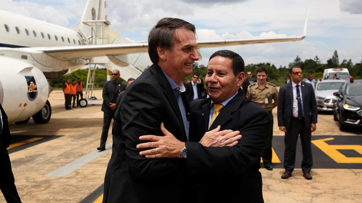 Bolsonaro y el vicepresidente se saludan a su bajada del avión en Brasilia