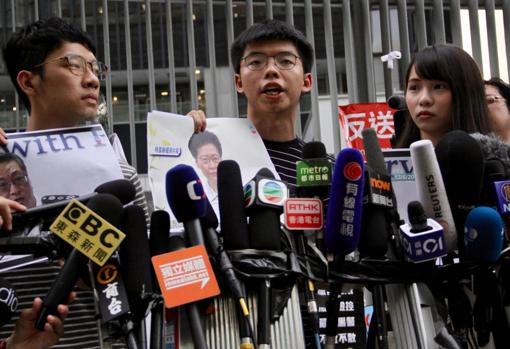 Joshua Wong (en el centro), junto a sus compañeros del partido Demosisto, Agnes Chow y Nathan Lau, en una protesta contra la jefa del Gobierno de Hong Kong, Carrie Lam