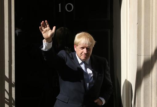 Boris Johnson saluda tras su discurso ante la puerta de su residencia oficial