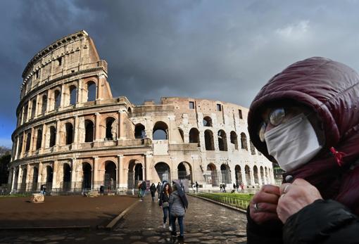 Un hombre con mascarilla pasa esta semana frente al Coliseo de Roma