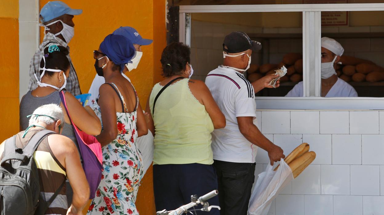 Un grupo de personas hace cola para comprar pan en La Habana