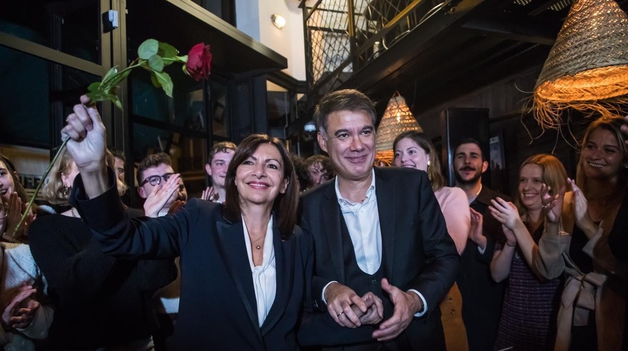 La ganadora de las primarias de la izquierda, la alcaldesa de París, Anne Hidalgo, sostiene una rosa junto al secretario general del Partido Socialista francés, Olivier Faure