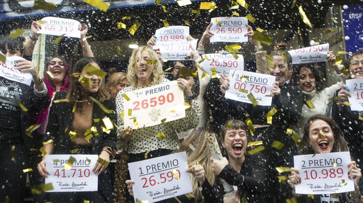 Un grupo de personas celebra sus premios de la Lotería de Navidad