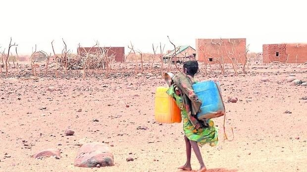 Una niña carga agua en el Sáhara