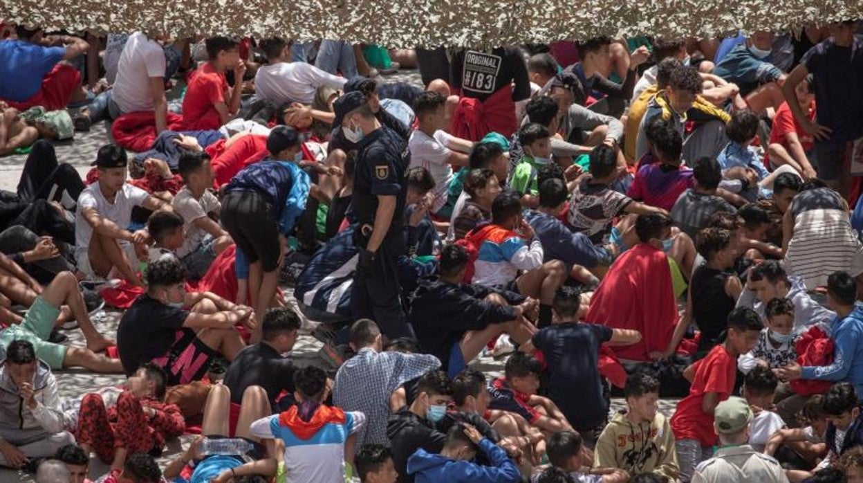 Decenas de migrantes en la nave de el polígono industrial cercano a la playa de El Tarajal.