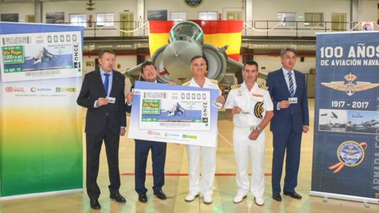 El director de la ONCE y el ALFLOT (centro portando cartel) durante el acto de presentación del cupón en la Base Naval de Rota.