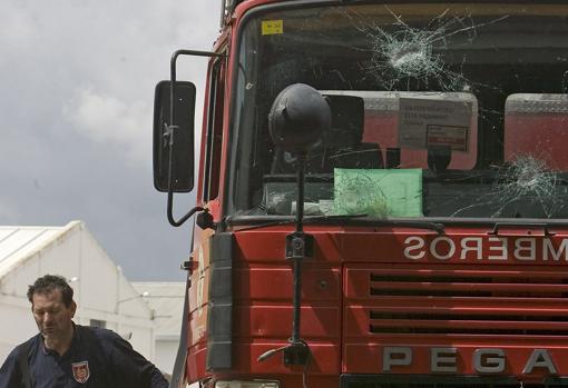 Camión de bomberos con las lunas rotas por el impacto de las piedras