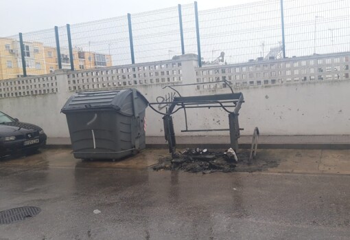 Los restos del contenedor quemado han permanecido en la calle durante la mañana del 21 de febrero