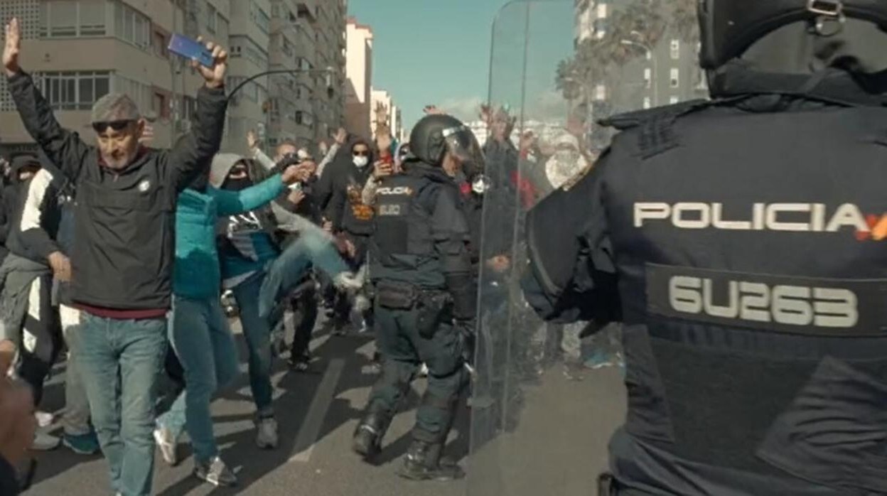 Momento en el que un manifestante encapuchado agrede a un policía durante los disturbios de la huelga del metal.