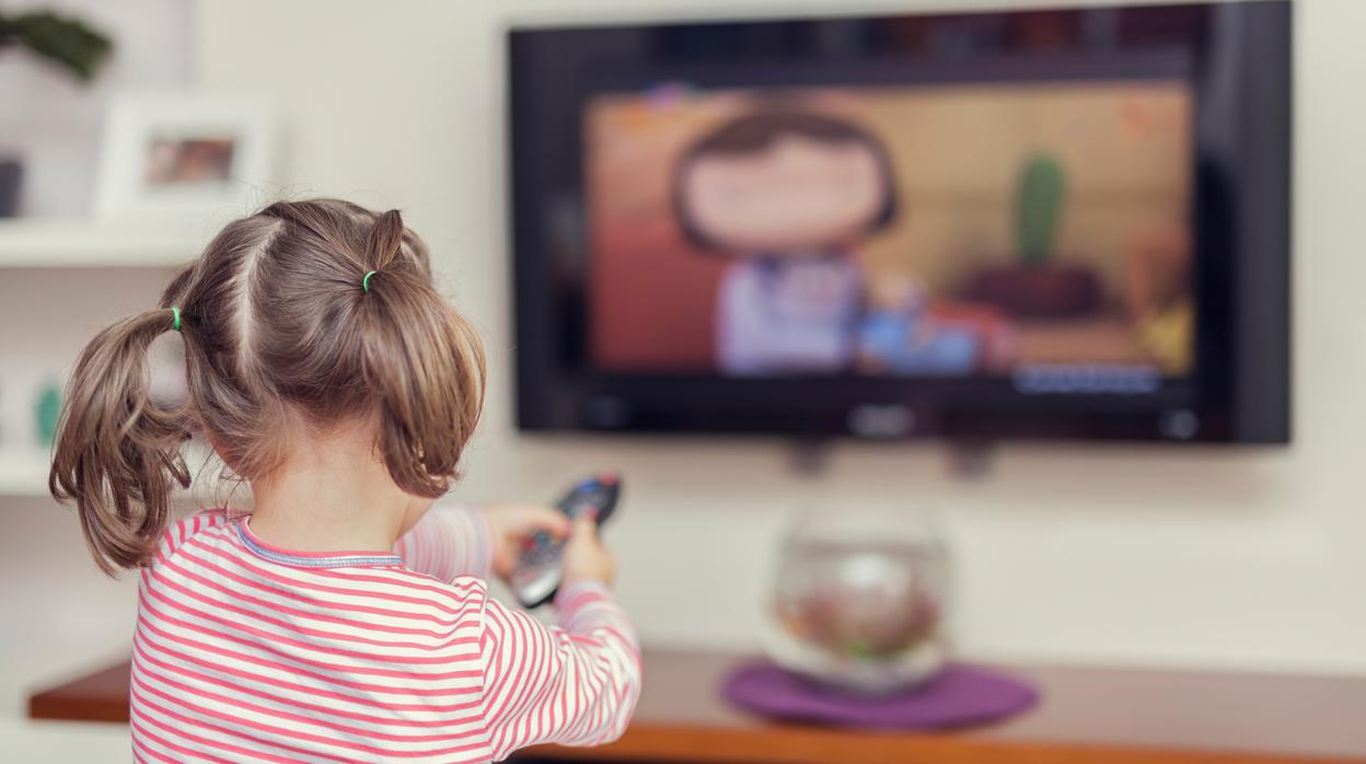 Niña viendo la televisión en casa