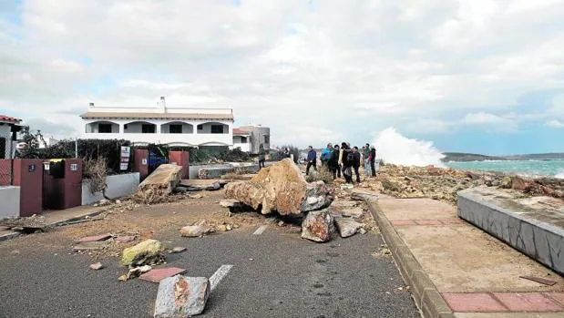 Varias personas observan los destrozos causados por el temporal de mar y viento en la urbanización de S'Algar en el municipio de Sant Lluís, Menorca