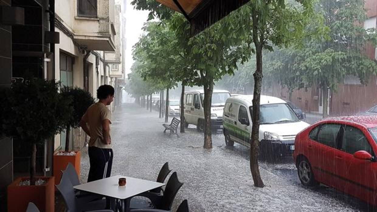 Un hombre observa desde la terraza de un bar de Soria la fuerte granizada que ha caído hoy en la ciudad. Los bomberos de Soria han atendido esta tarde durante unas tres horas un total de 21 avisos sobre diversas incidencias, entre otras algunas inundaciones de locales, causadas por una tormenta de granizo