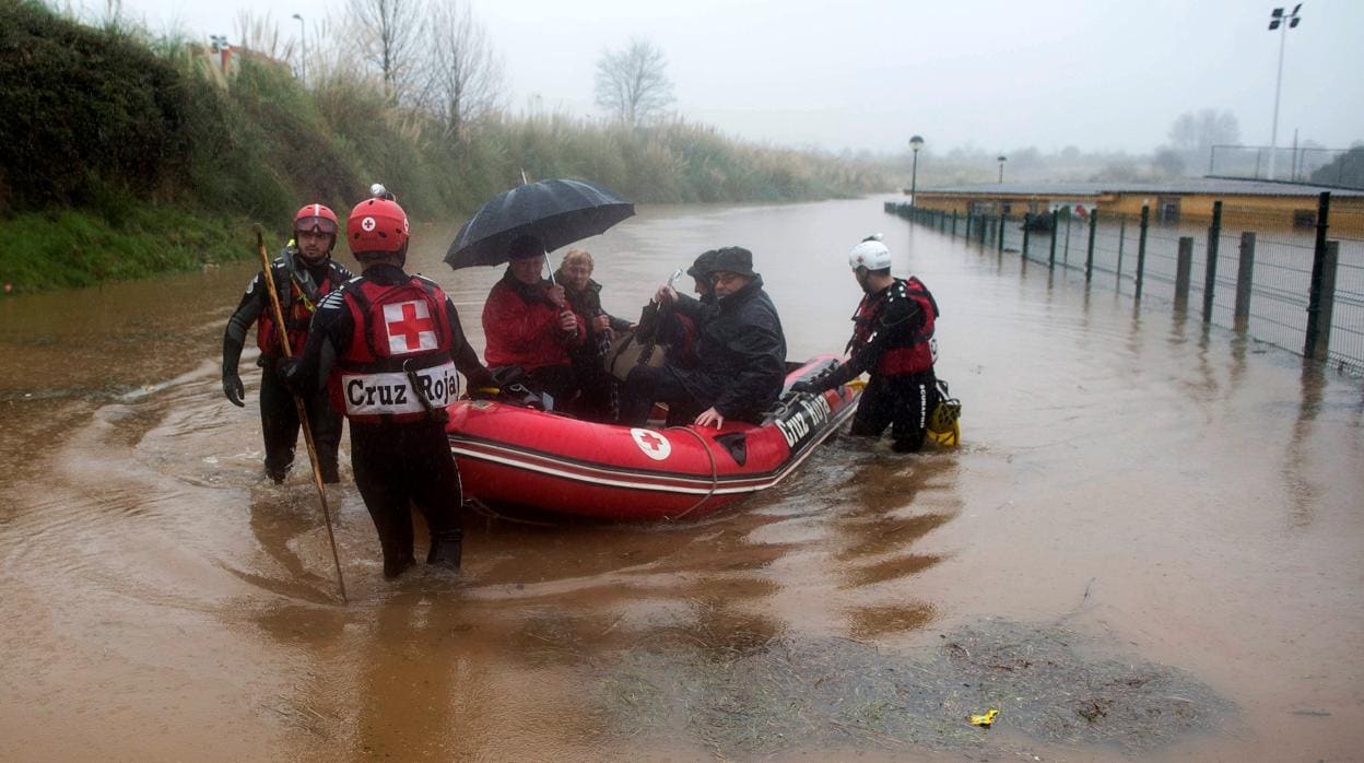 Efectivos de Cruz Roja rescatan a afectados por las inundaciones en la localidad de Hinojedo, en Cantabria